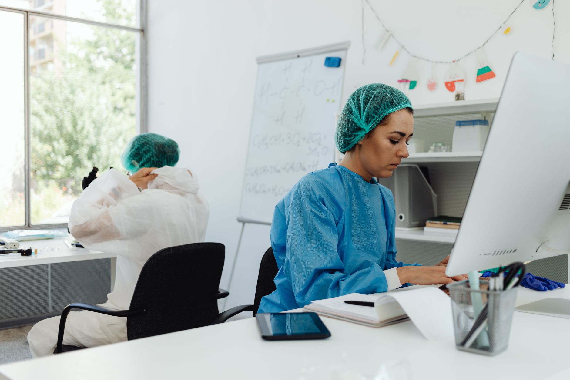 Healthcare staffing professionals reviewing contracts and scheduling documents in an office setting