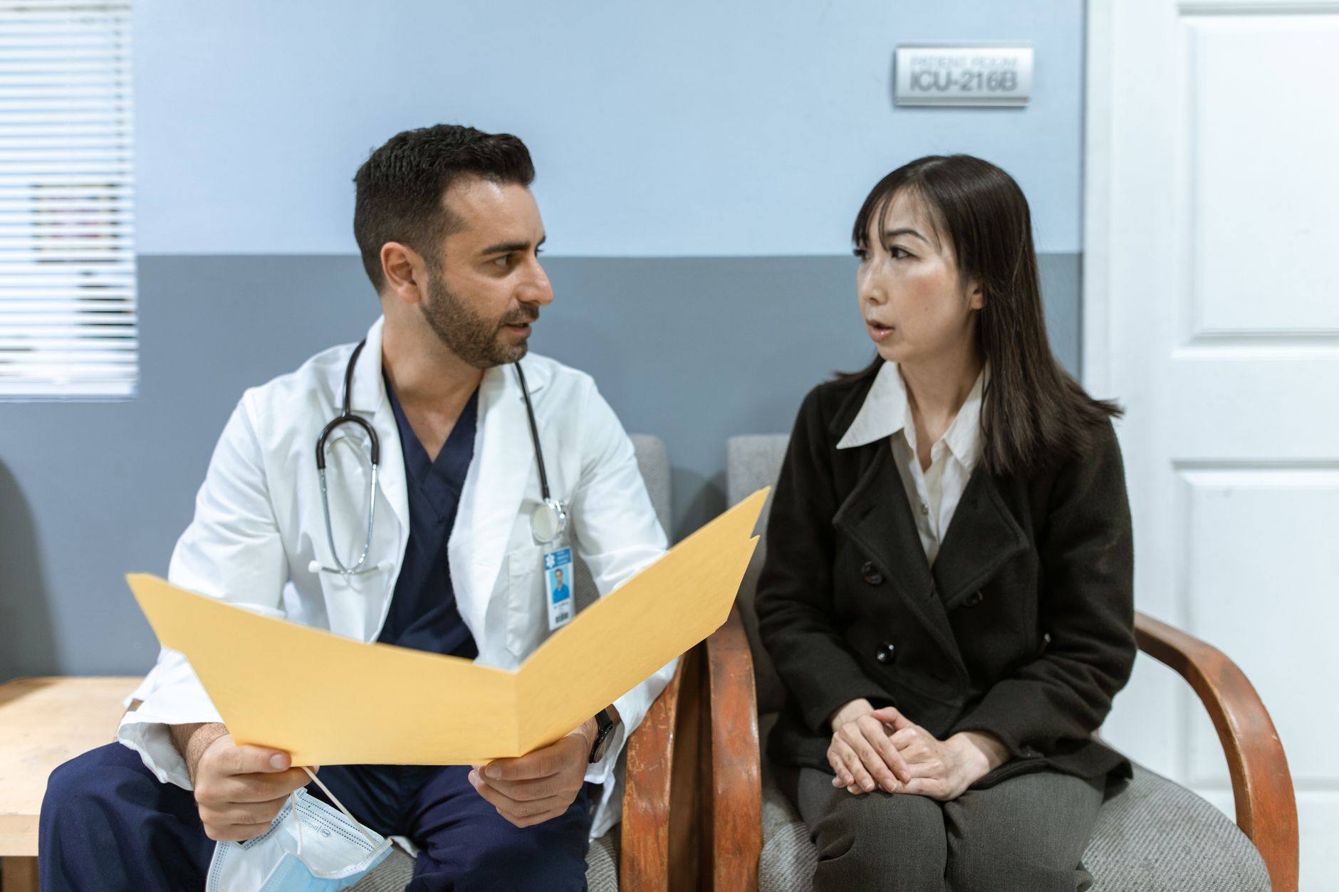 Healthcare administrators reviewing documents in a clinical office setting