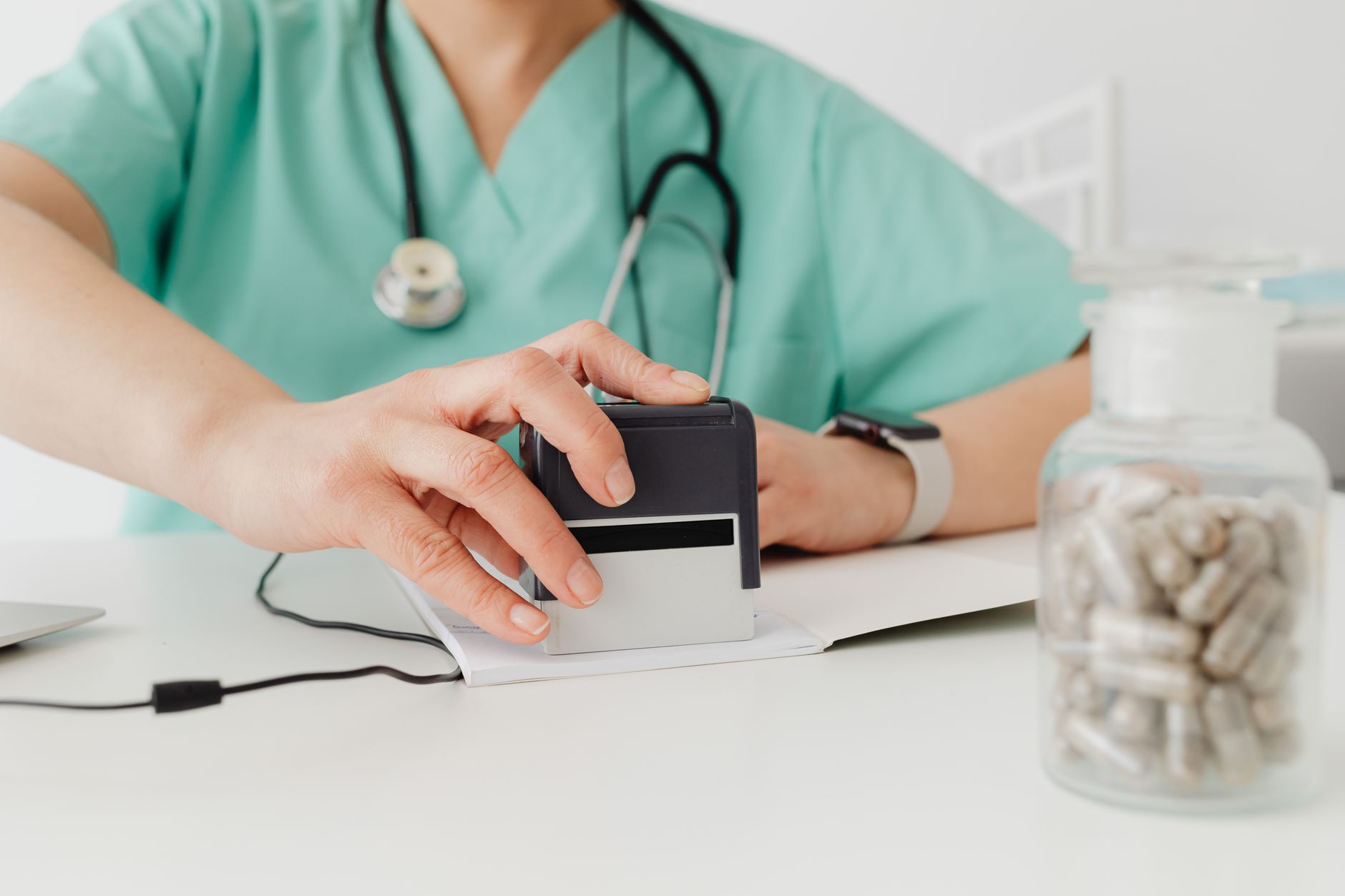 Healthcare administrator reviewing medical billing documents at a desk