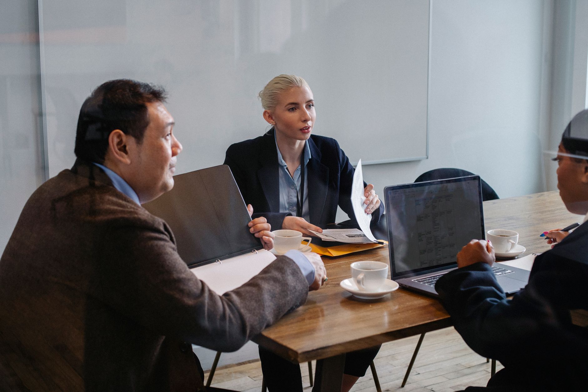 Medical professionals reviewing documents in a conference room during a business discussion