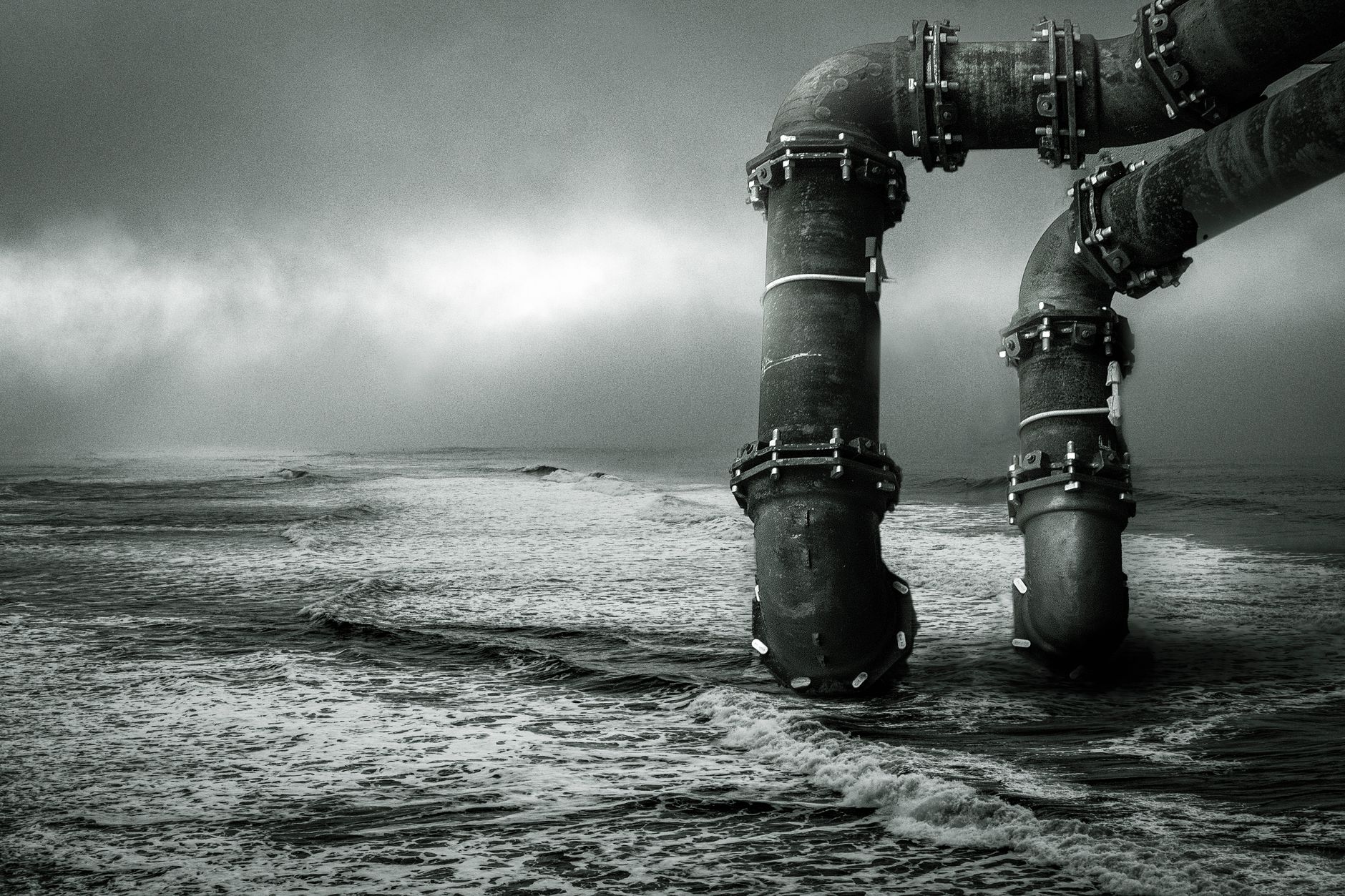 Workers inspecting water infrastructure pipes at an industrial facility