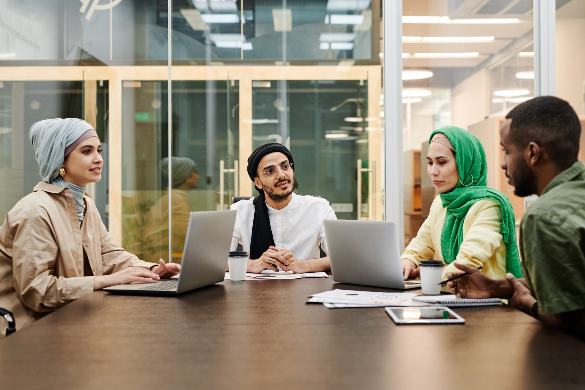 Corporate professionals reviewing contract documents during a business meeting