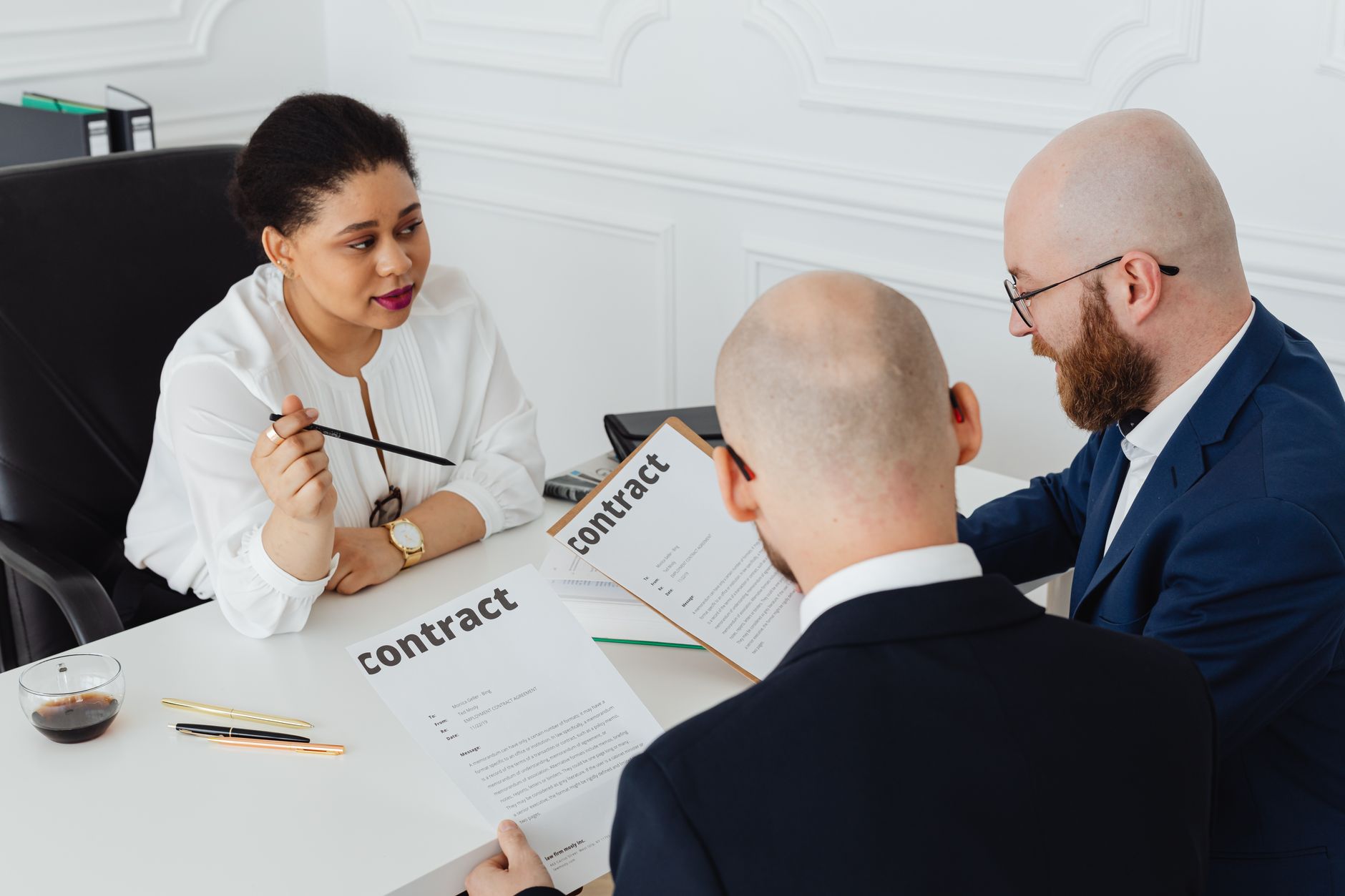 Business professionals reviewing documents at a conference table during a meeting