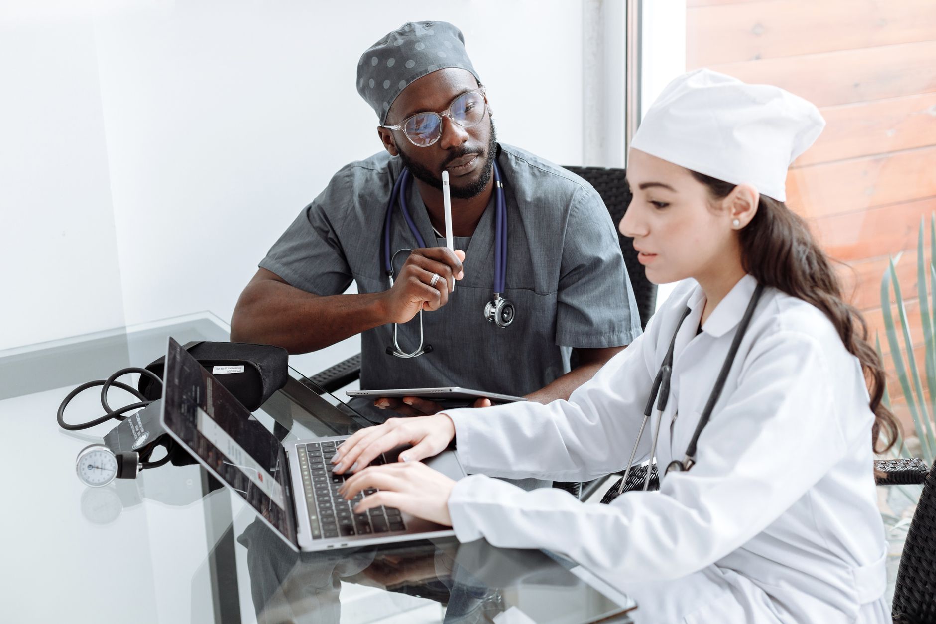 Physicians and administrators discussing business terms in a conference room