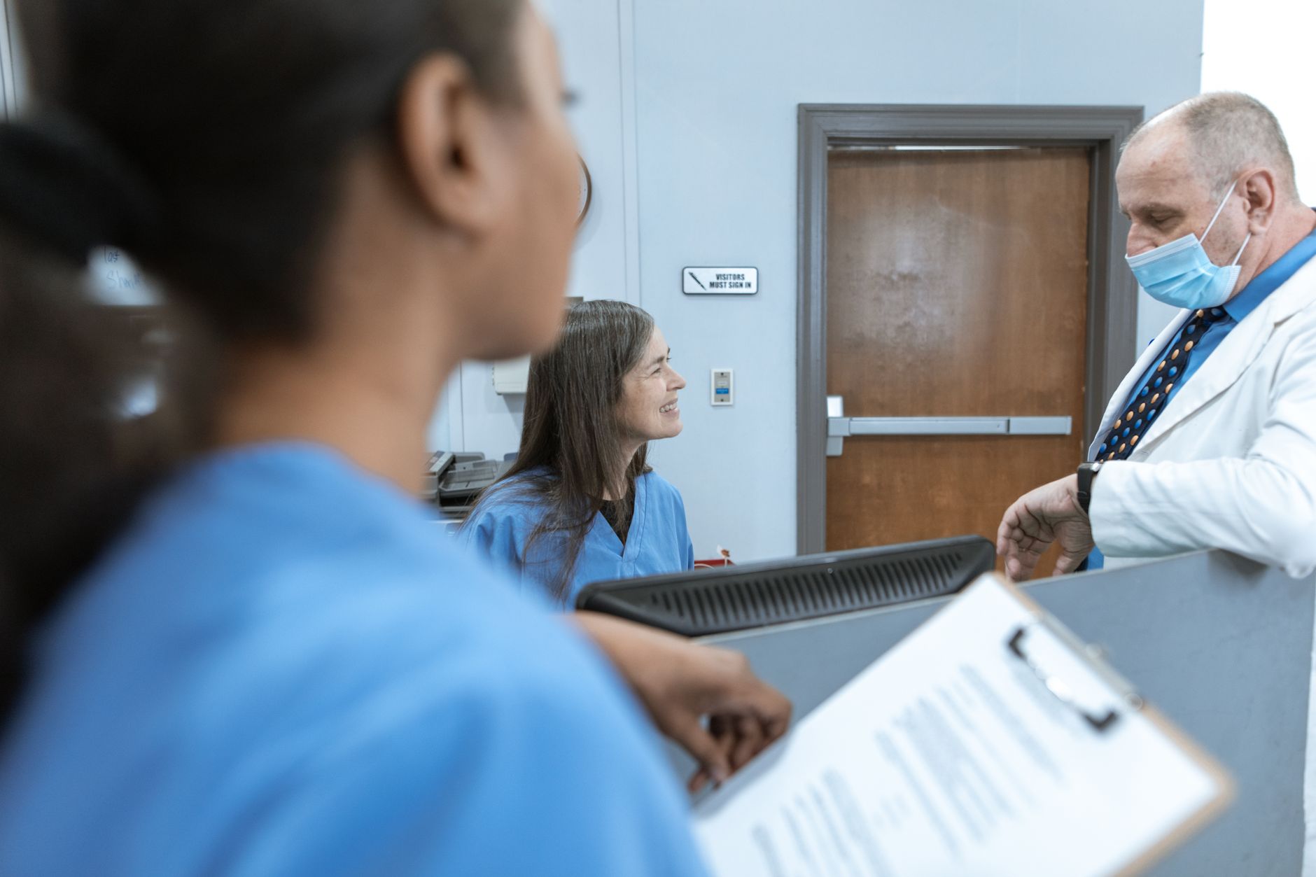 Physicians in a meeting discussing practice management and institutional decisions