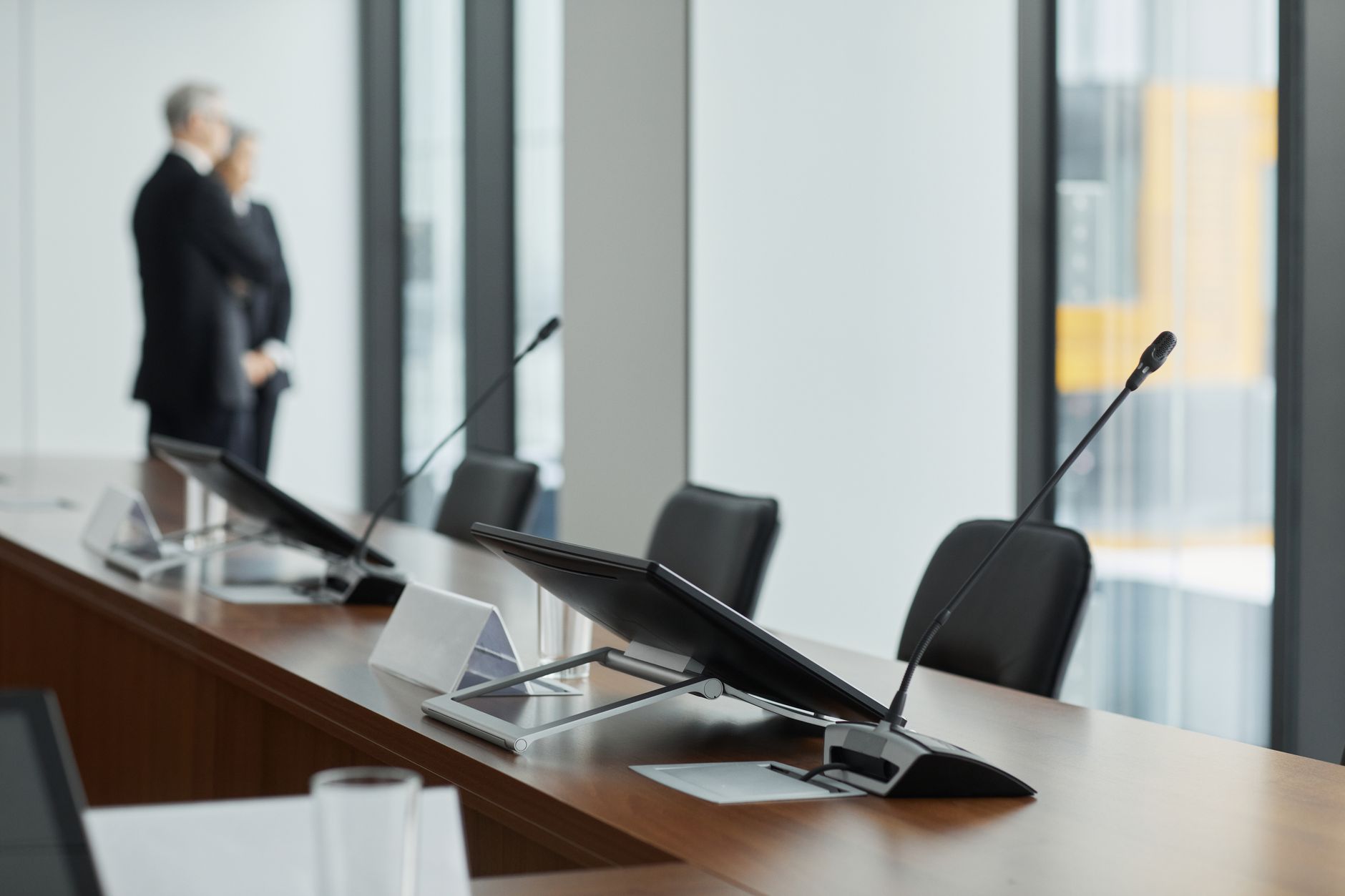 Medical professionals and executives seated around a conference table in discussion
