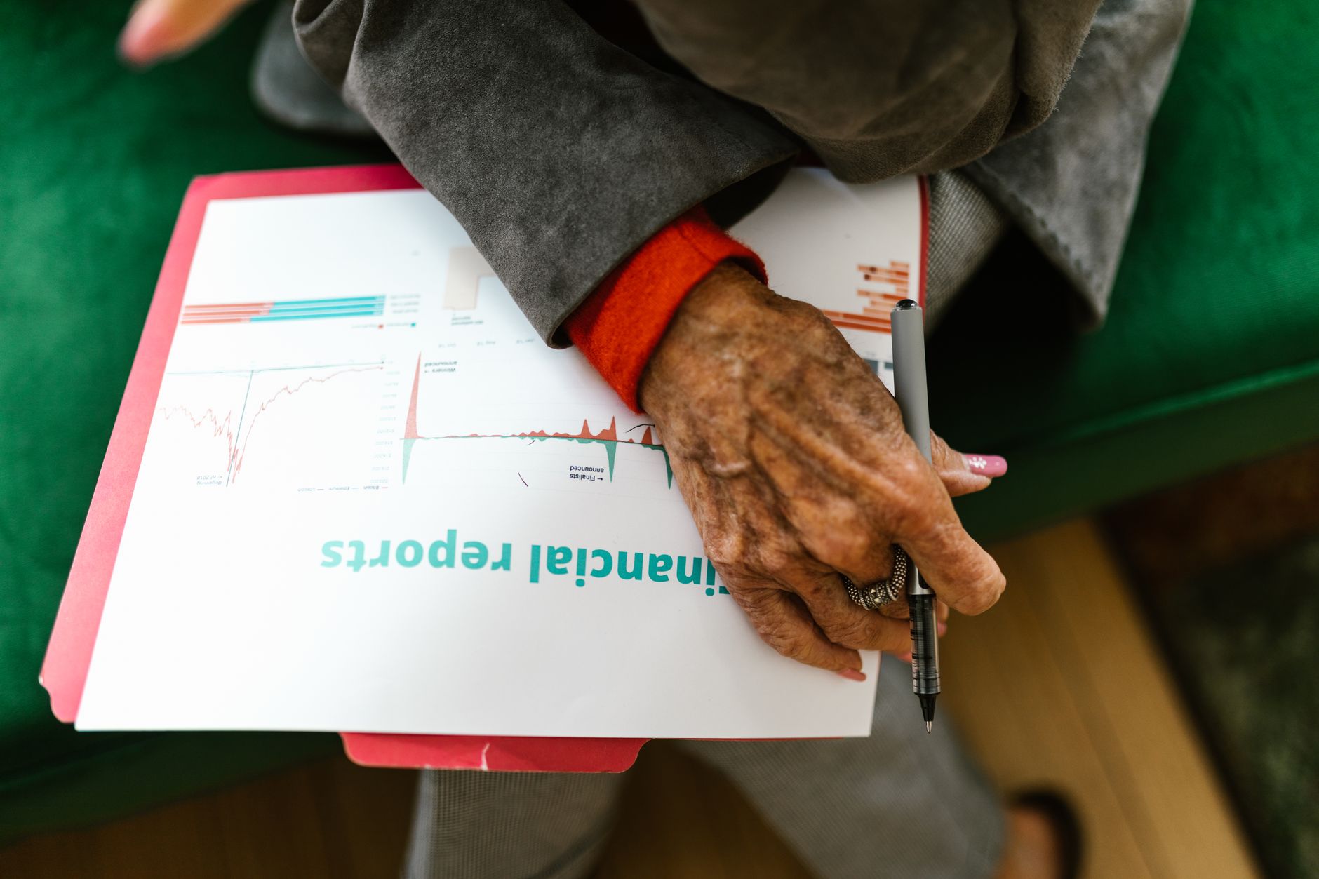 Financial documents and spreadsheets spread across a desk representing accounting firm transactions