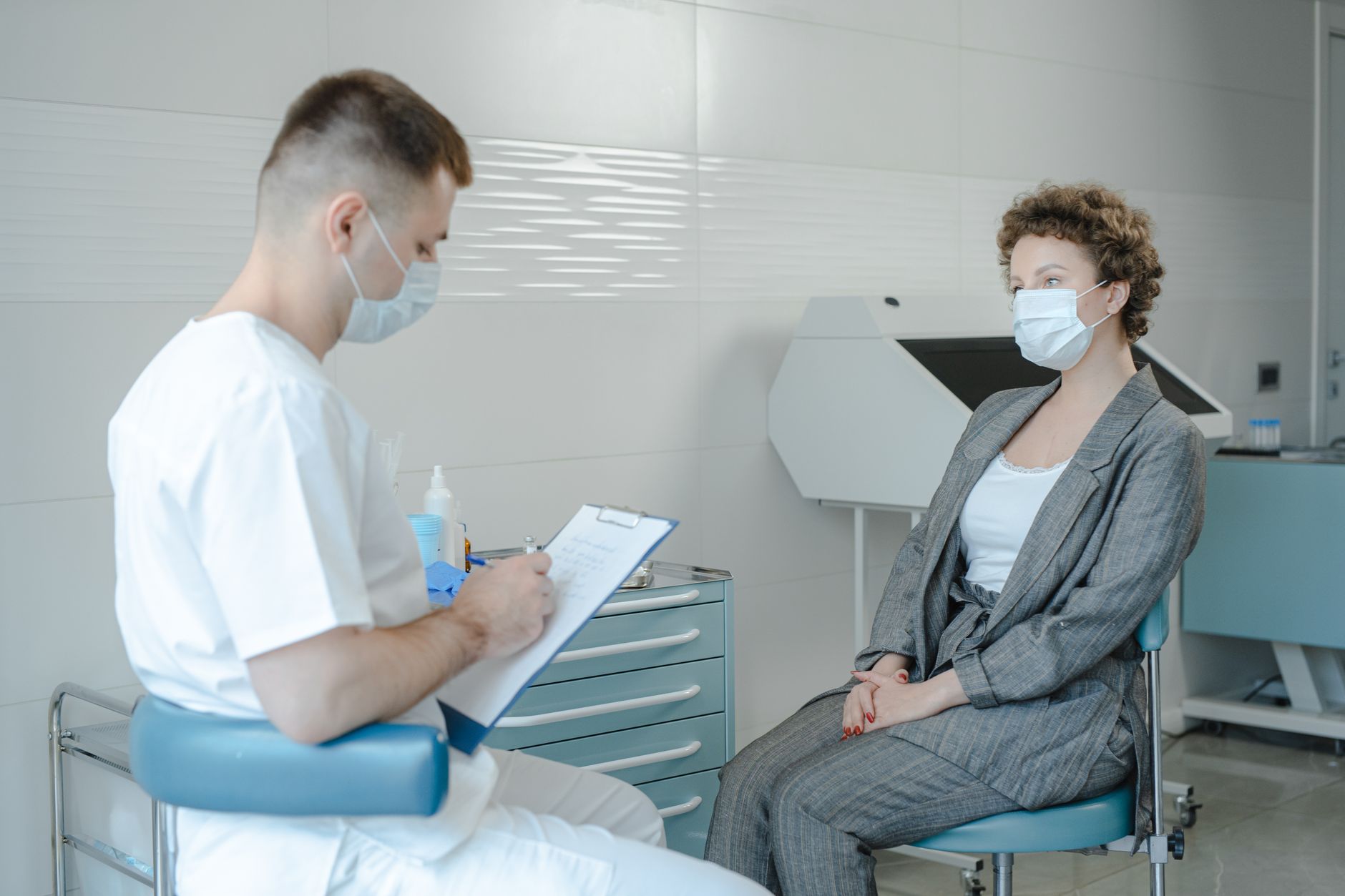 A physician consulting with a patient in a clinical setting during an appointment