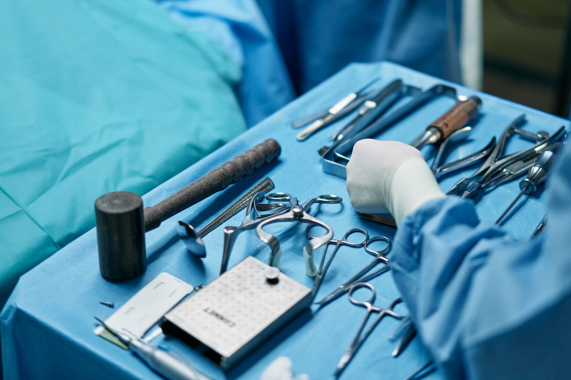 Orthopedic surgical instruments laid out on a sterile operating table