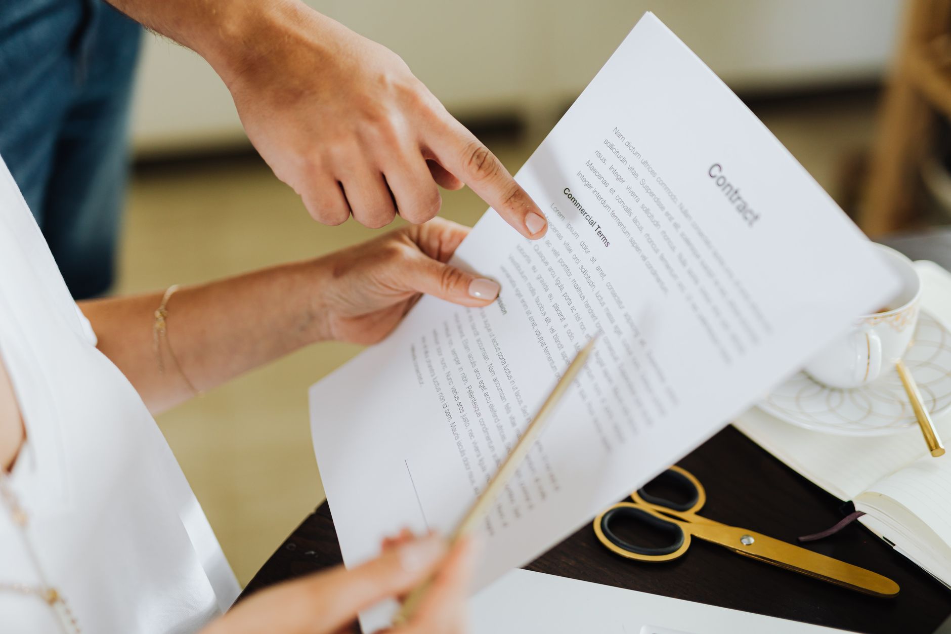 Two professionals reviewing documents at a table representing a clinic acquisition deal