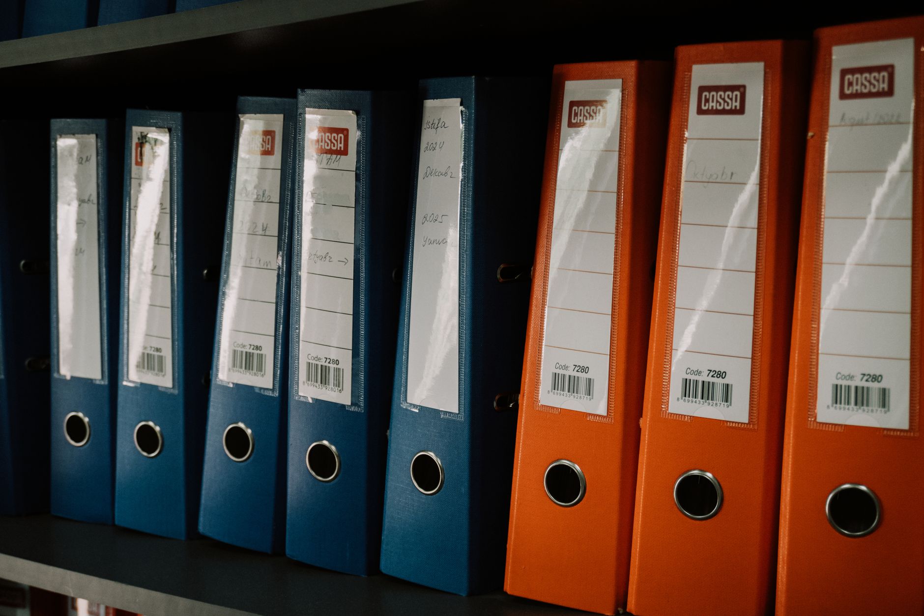 Stack of documents and a pen on a desk in a professional office setting