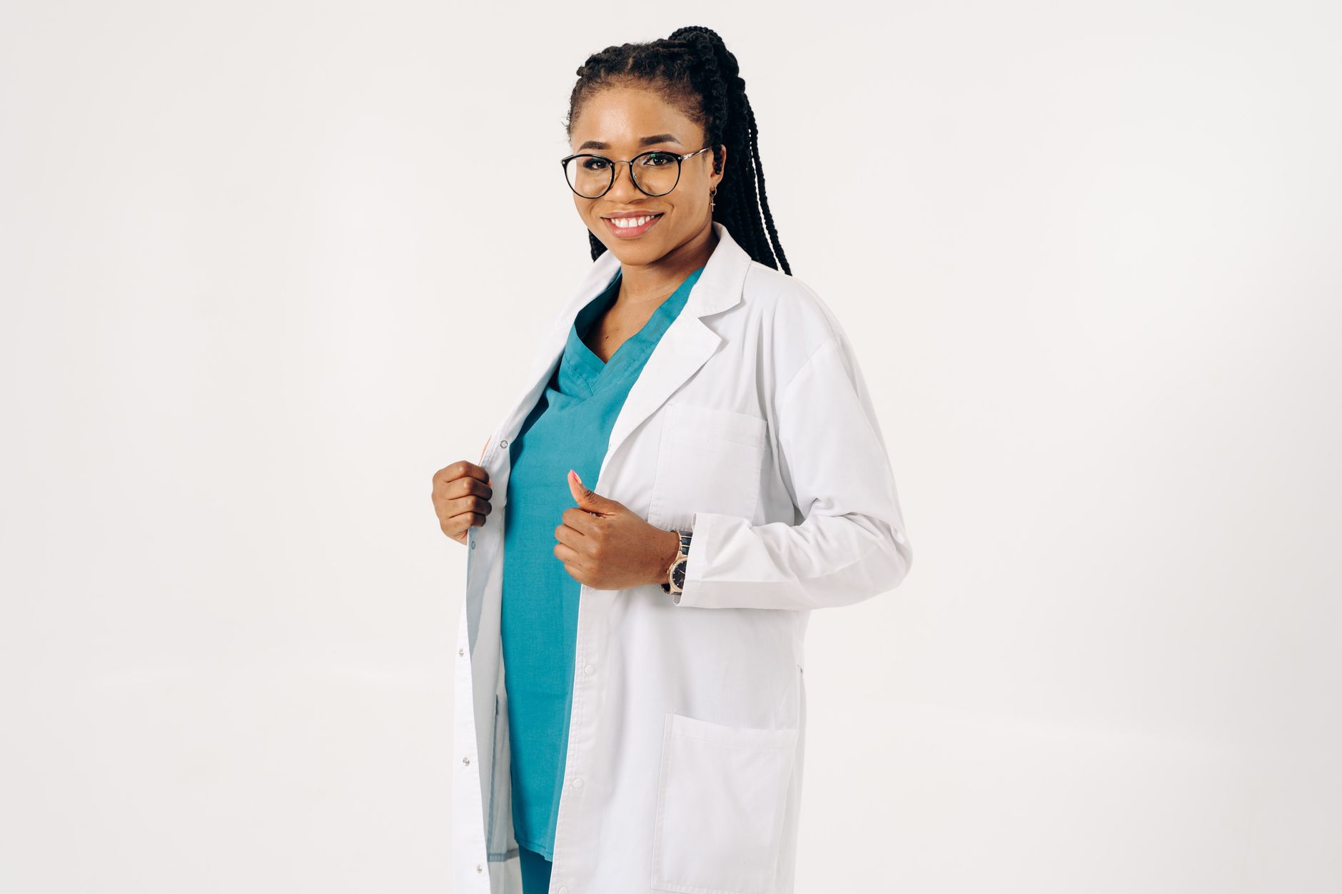 A home health worker standing in a residential hallway looking at their phone