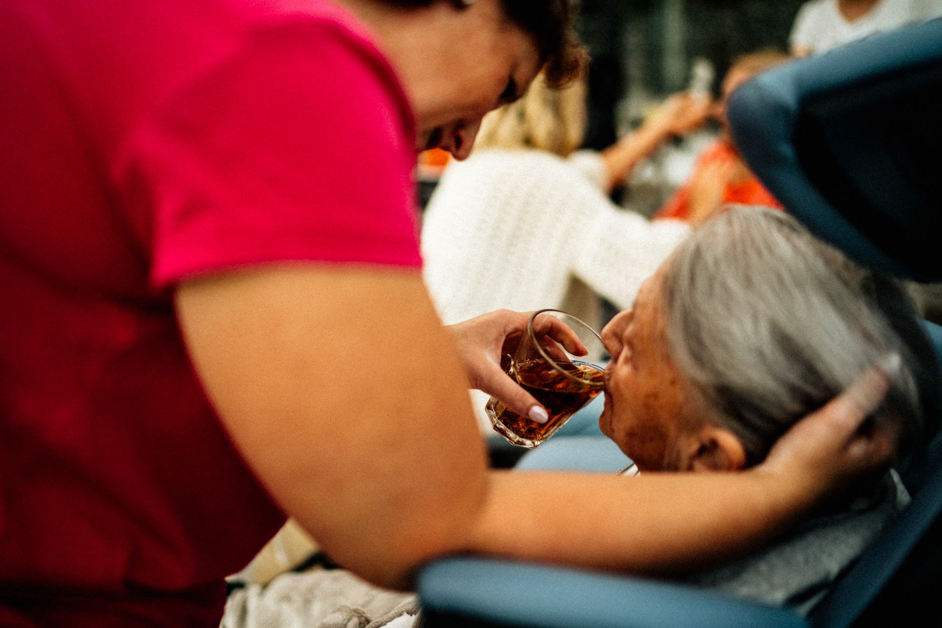A nurse providing care to an elderly patient in a home hospice setting