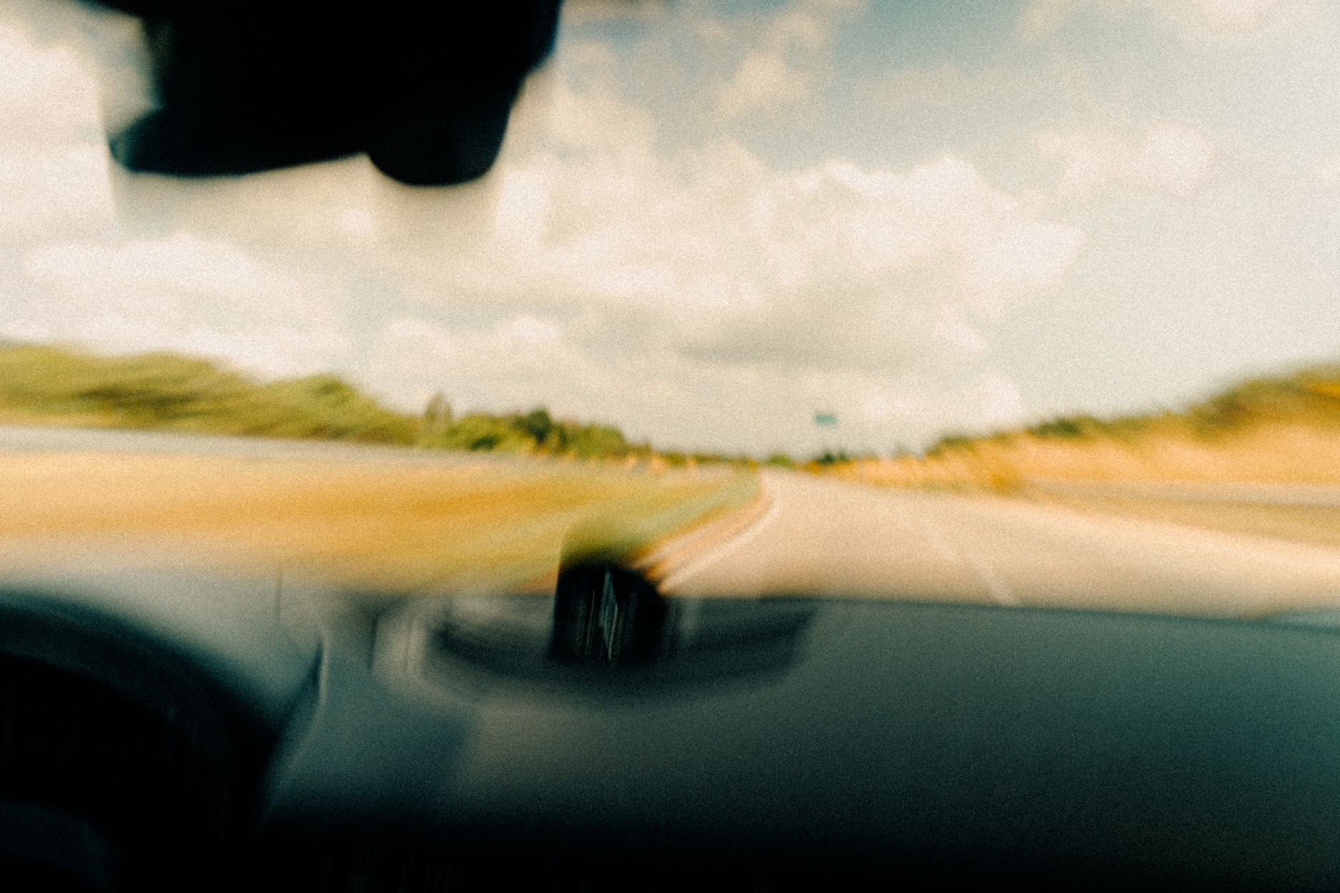A long rural road representing the travel challenges facing hospice staffing in remote areas