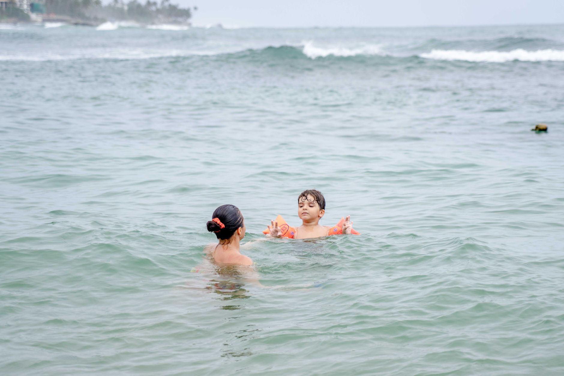 Swim instructor working one-on-one with a young child in a pool