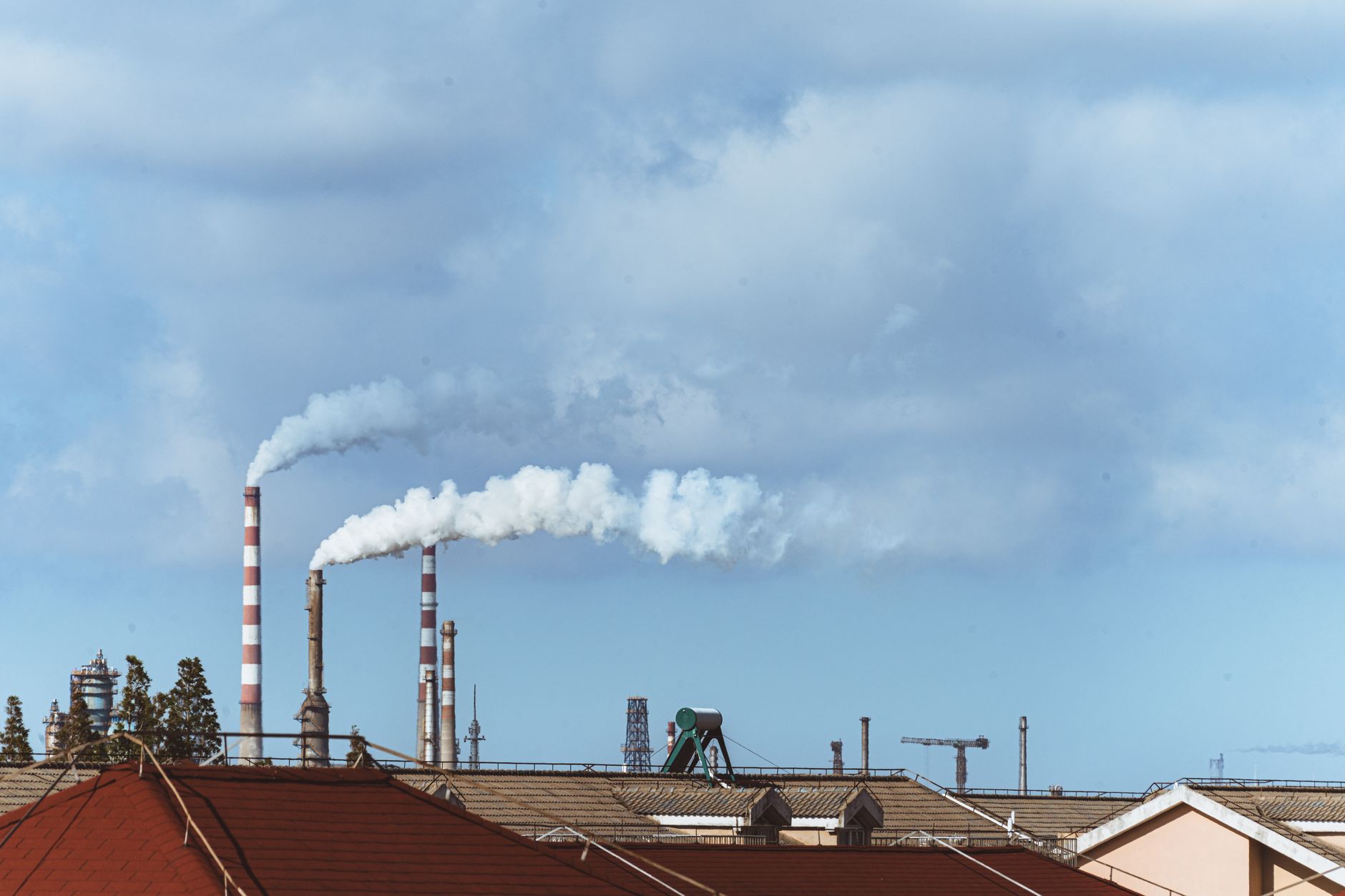 Wide shot of an industrial steel processing facility with machinery and workers