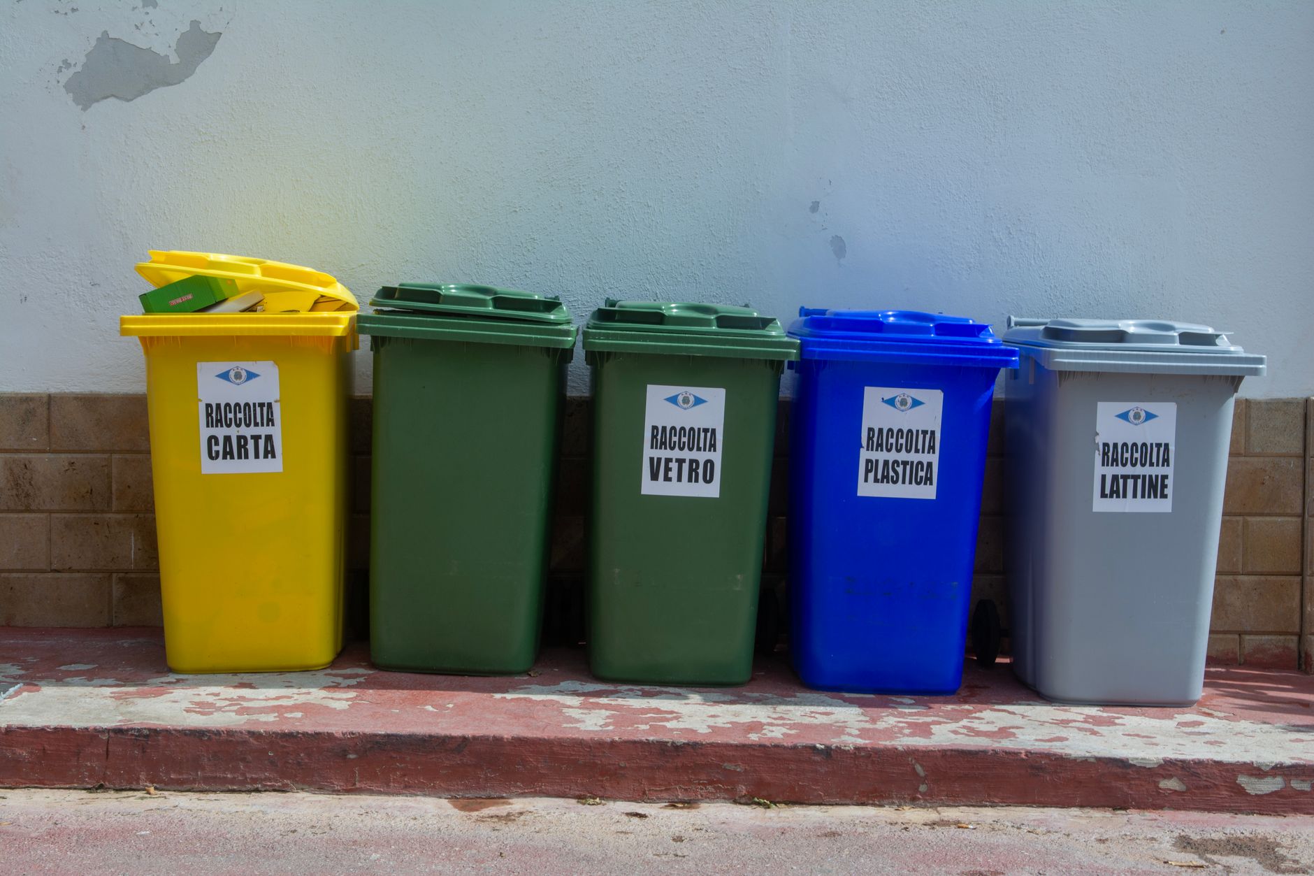 A fleet of waste management trucks parked at an industrial facility