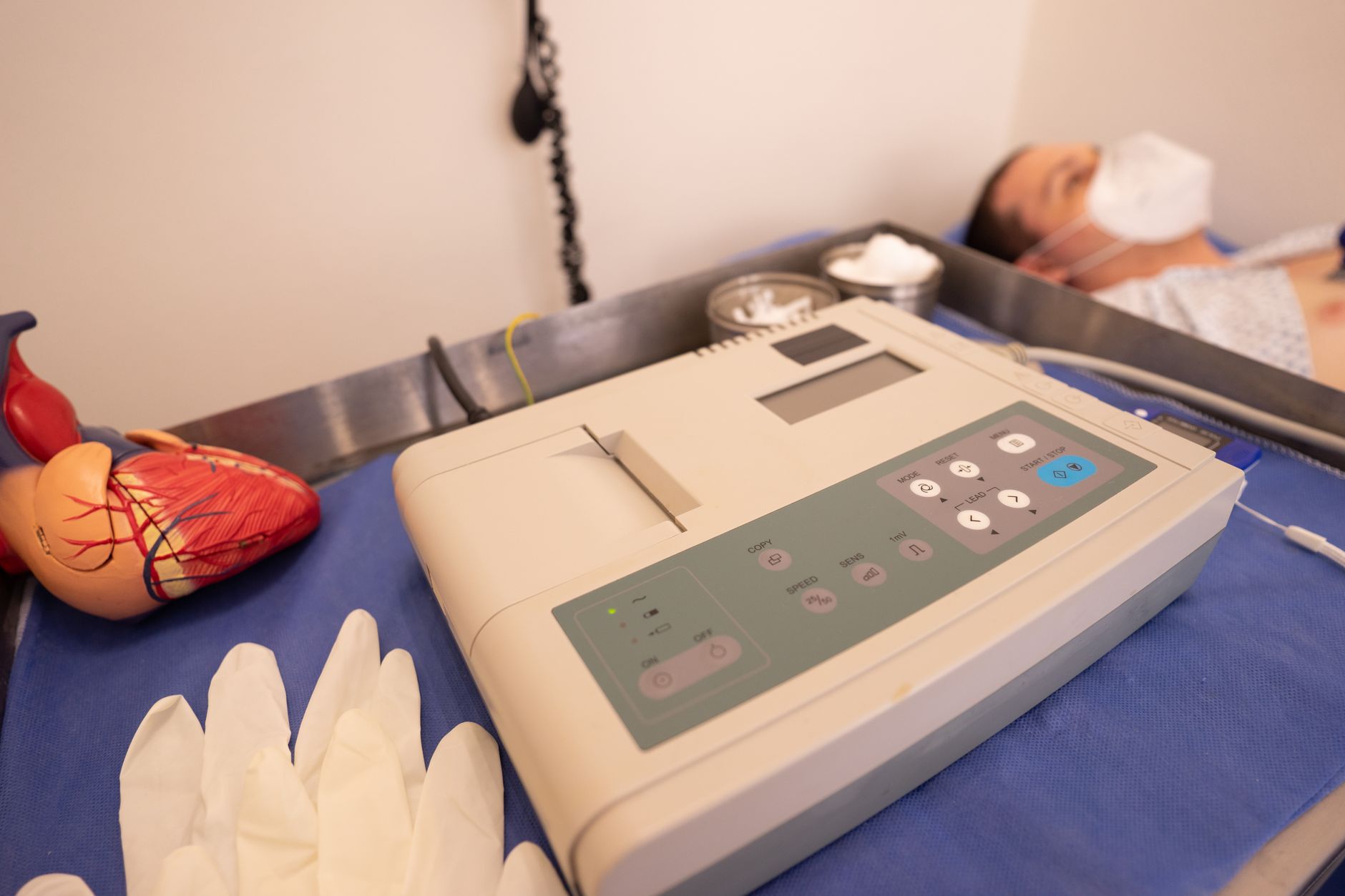A cardiac monitor displaying vital signs in a hospital setting