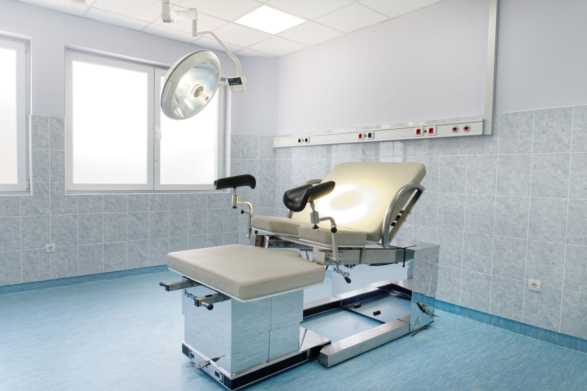 Interior of a quiet medical office with reception desk and waiting area chairs