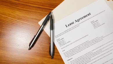 Person signing real estate closing documents at a desk