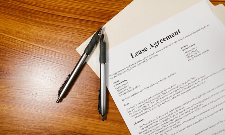 Person signing real estate closing documents at a desk
