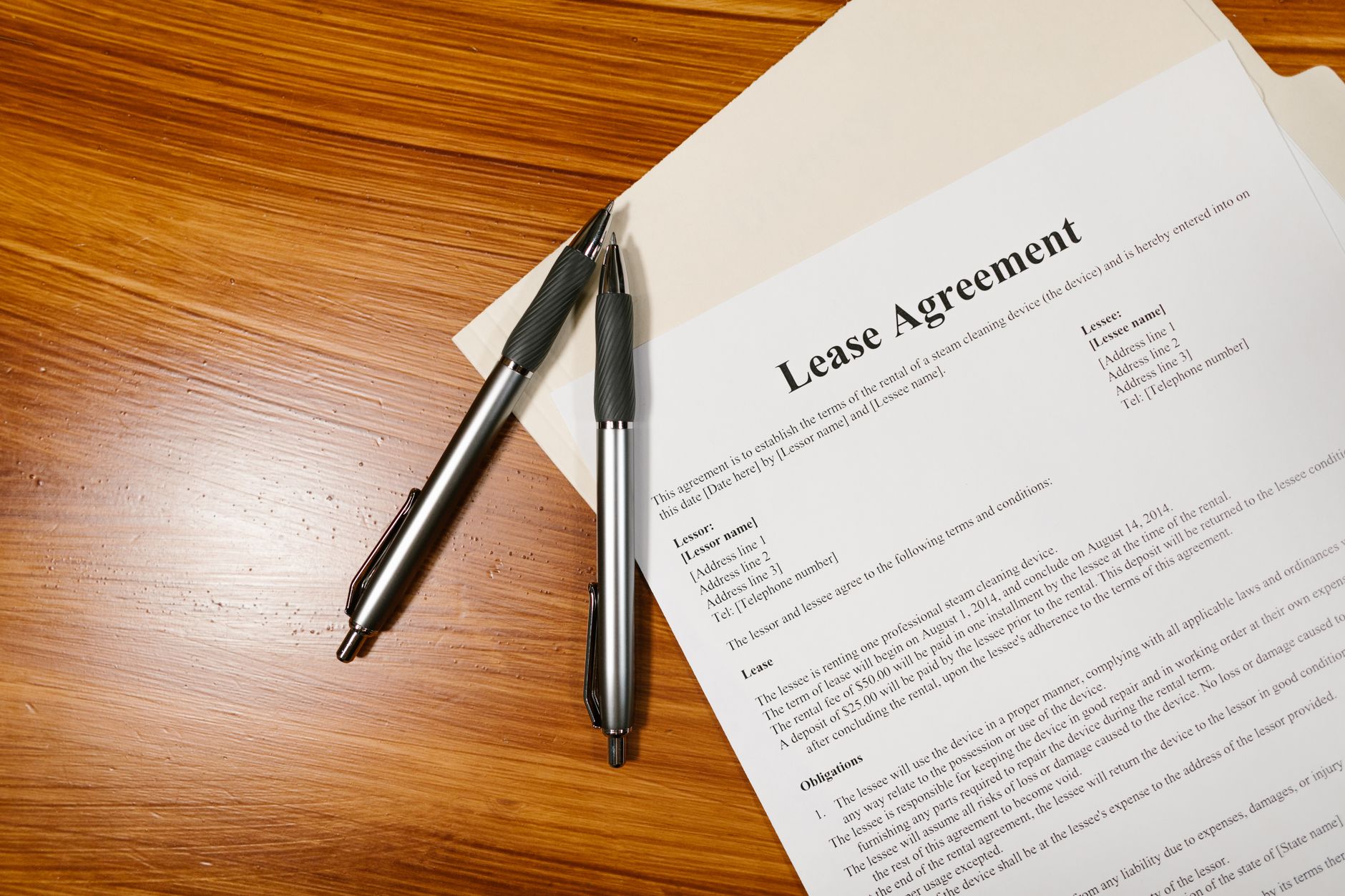Person signing real estate closing documents at a desk