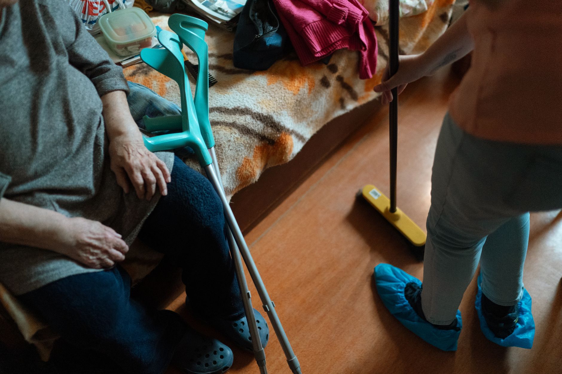 A caregiver sitting beside an elderly patient in a hospice setting