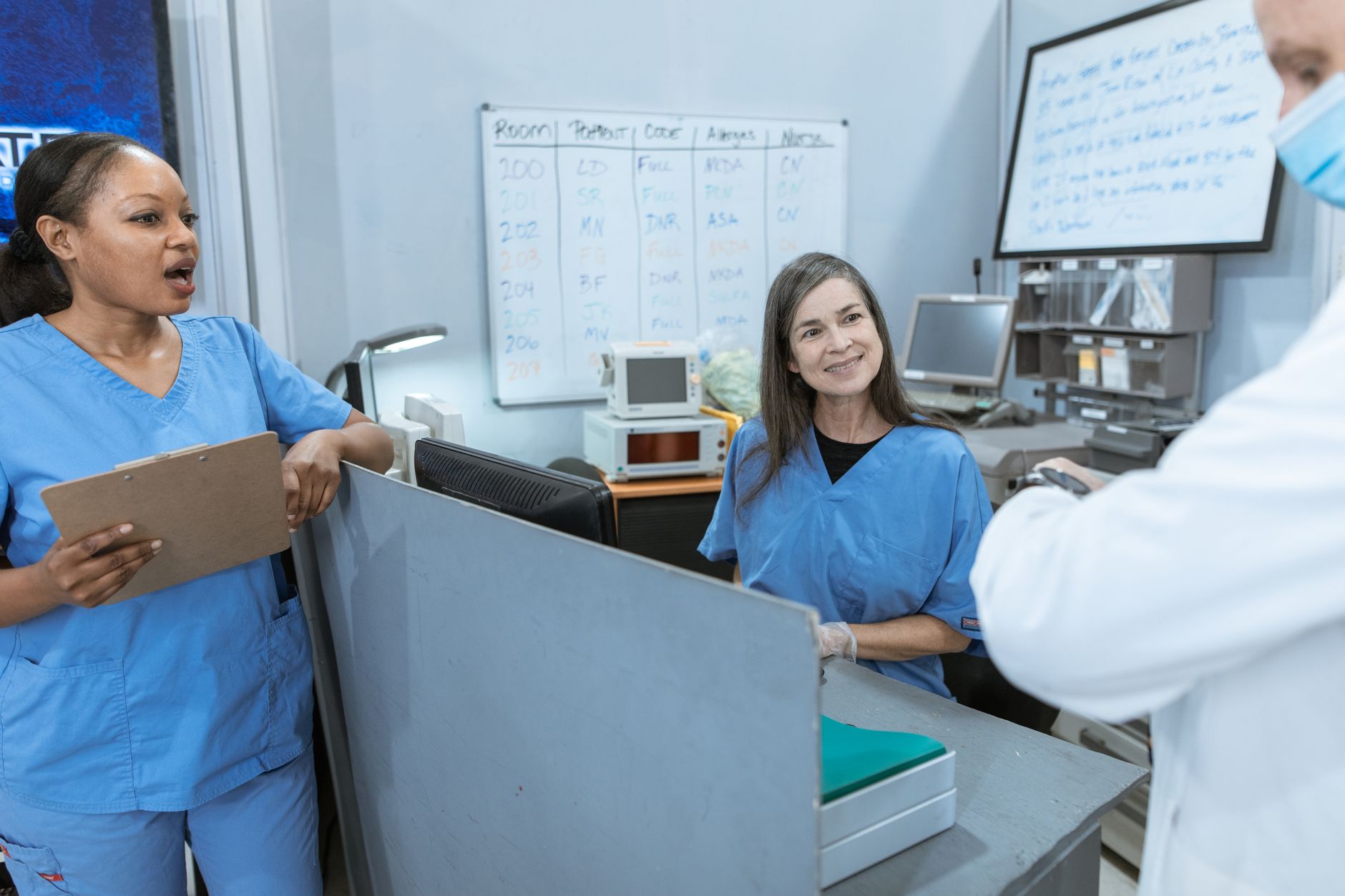 Healthcare staffing professionals reviewing documents in an office setting