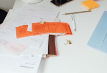 Mortgage documents and paperwork laid out on a desk representing a home loan servicing transaction