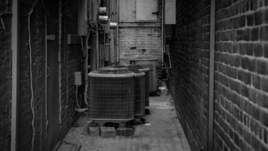 HVAC technician working on an outdoor air conditioning unit