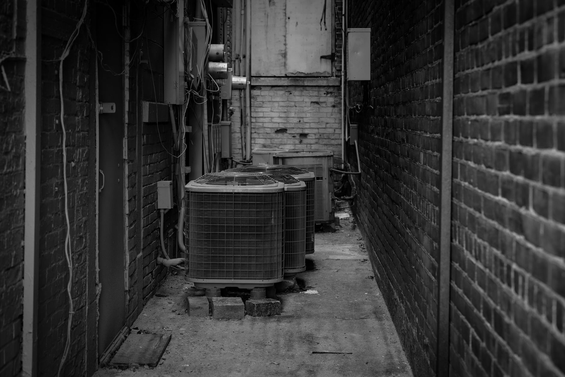 HVAC technician working on an outdoor air conditioning unit