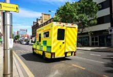 Ambulance driving through a city street representing regional emergency medical services