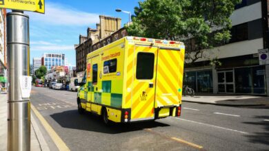 Ambulance driving through a city street representing regional emergency medical services