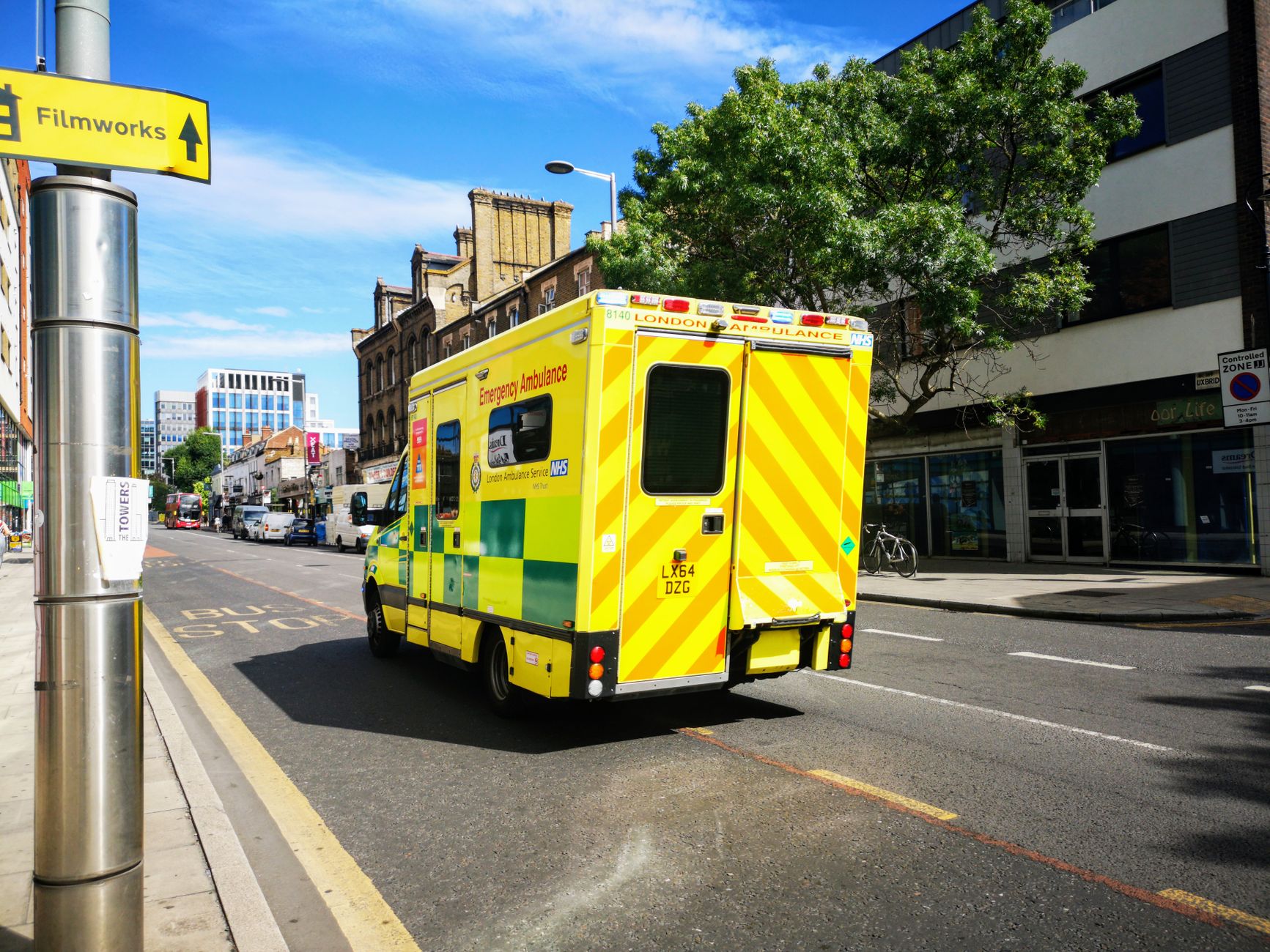 Ambulance driving through a city street representing regional emergency medical services
