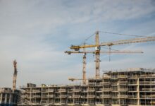 Large construction crane on an industrial worksite against a clear sky
