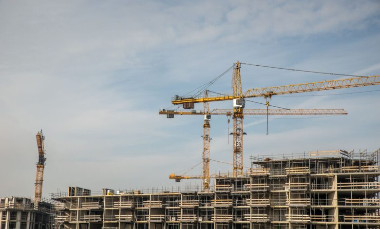 Large construction crane on an industrial worksite against a clear sky