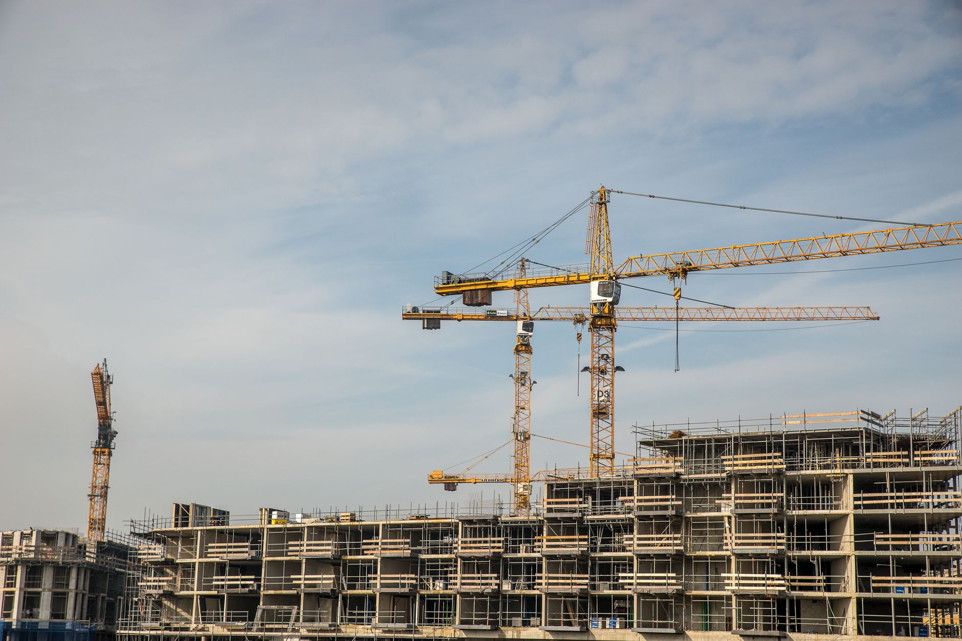 Large construction crane on an industrial worksite against a clear sky