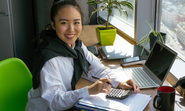 A business professional reviewing accounting software on a desktop computer in a modern office setting