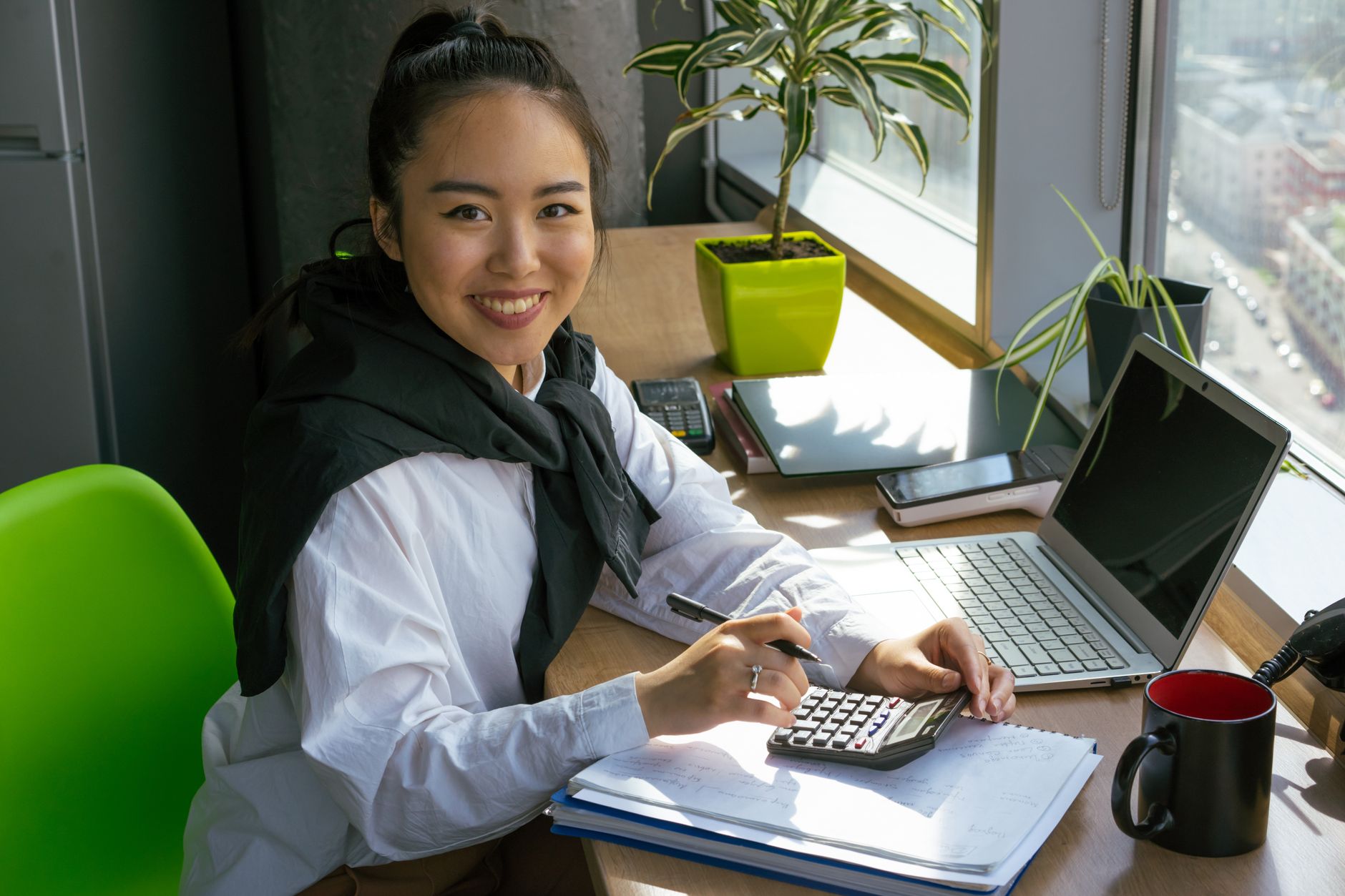 A business professional reviewing accounting software on a desktop computer in a modern office setting