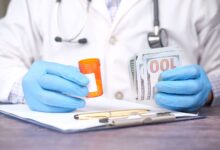 Medical billing specialist working at a desk reviewing insurance claims documents
