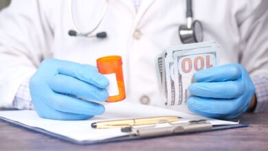 Medical billing specialist working at a desk reviewing insurance claims documents