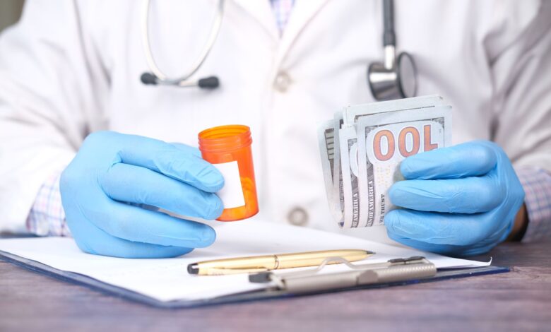 Medical billing specialist working at a desk reviewing insurance claims documents