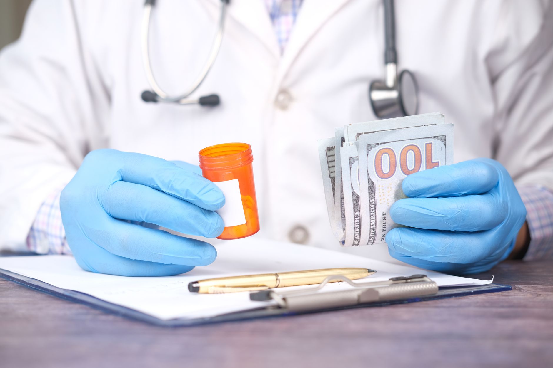 Medical billing specialist working at a desk reviewing insurance claims documents