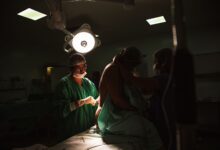 Surgeons performing an orthopedic procedure in a modern operating room