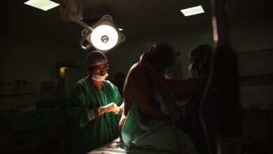 Surgeons performing an orthopedic procedure in a modern operating room