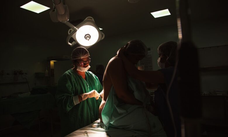 Surgeons performing an orthopedic procedure in a modern operating room
