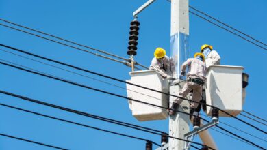 Electrician working on an industrial electrical panel at a commercial construction site