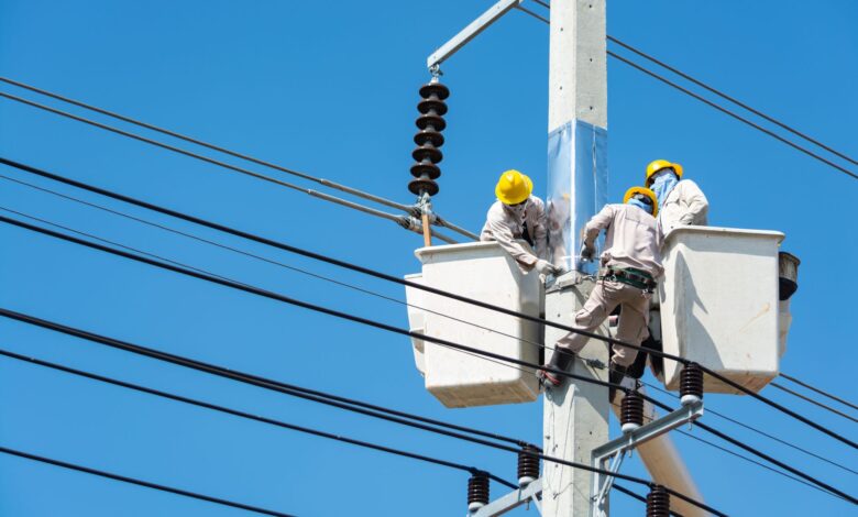 Electrician working on an industrial electrical panel at a commercial construction site
