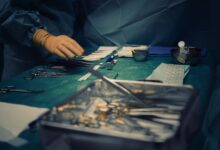 Surgeons performing an orthopedic procedure in a modern operating room