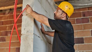 Electrician working on commercial wiring panel at a job site